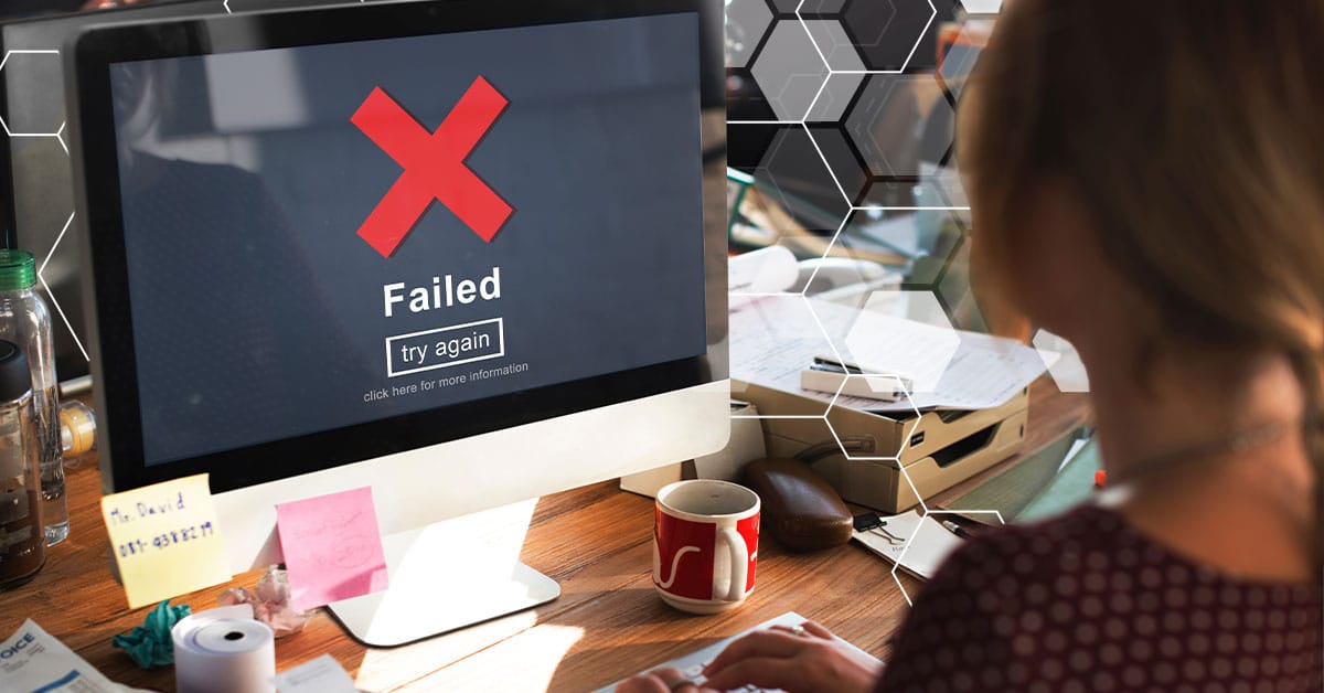 Someone looking at a computer screen that says "failed" on it.